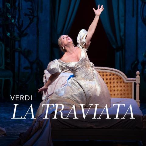 Violetta in evening gown on her bed.