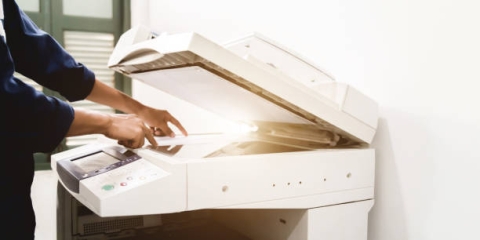 Person making copies at printer